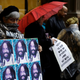 A protester holds up a poster depicting Mumia Abu-Jamal during a demonstration Dec. 28, 2018, outside the offices of Philadelphia District Attorney Larry Krasner.